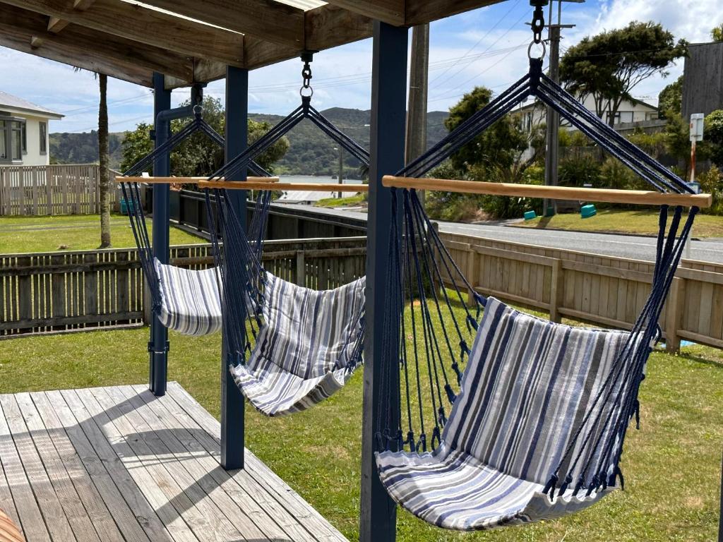 two hammocks hanging from a gazebo at Relaxing Raglan & the Boat House in Raglan