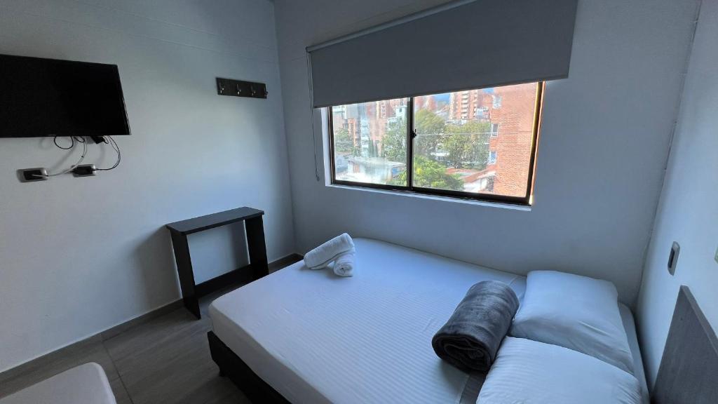 Postel nebo postele na pokoji v ubytování Hotel Jardin de Laureles Jeps