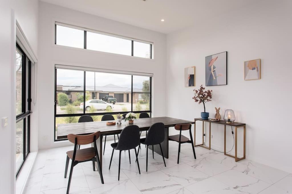a dining room with a table and chairs at Bright and Chic House at Throsby with 4 Bedrooms in Harrison