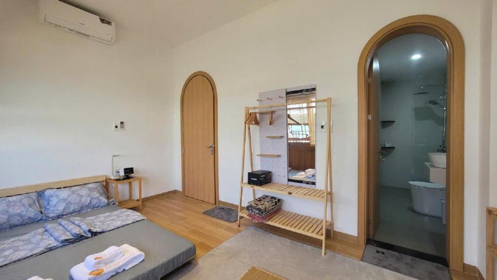 ein Wohnzimmer mit einer Couch und einem Spiegel in der Unterkunft Hue House - Zen Gần Aeon Mall Huế in Thôn Trường Giang