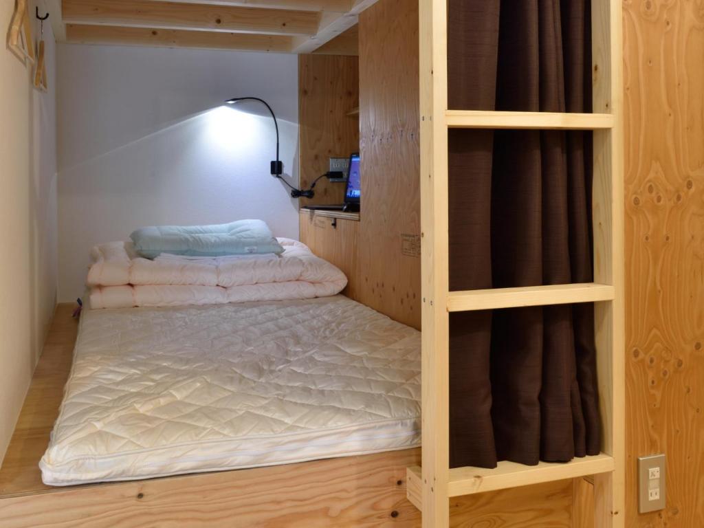 Postel nebo postele na pokoji v ubytování Hostel Mitsuwaya Osaka