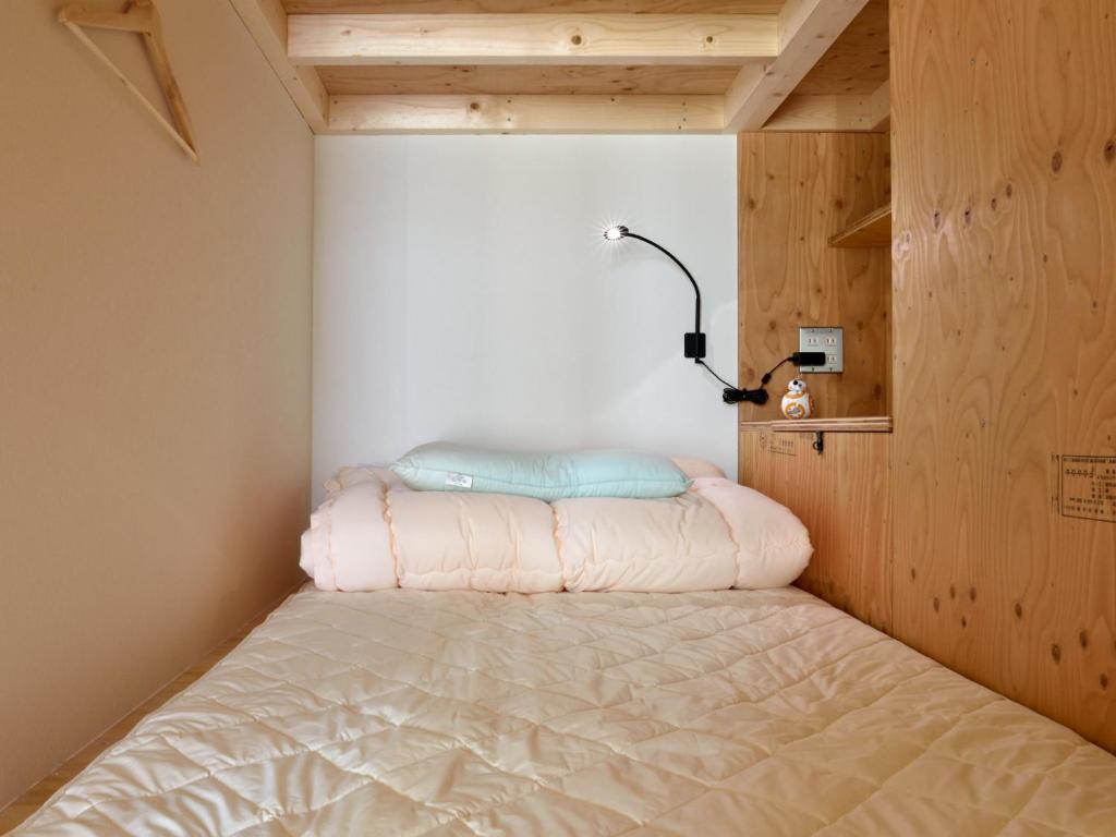 Postel nebo postele na pokoji v ubytování Hostel Mitsuwaya Osaka