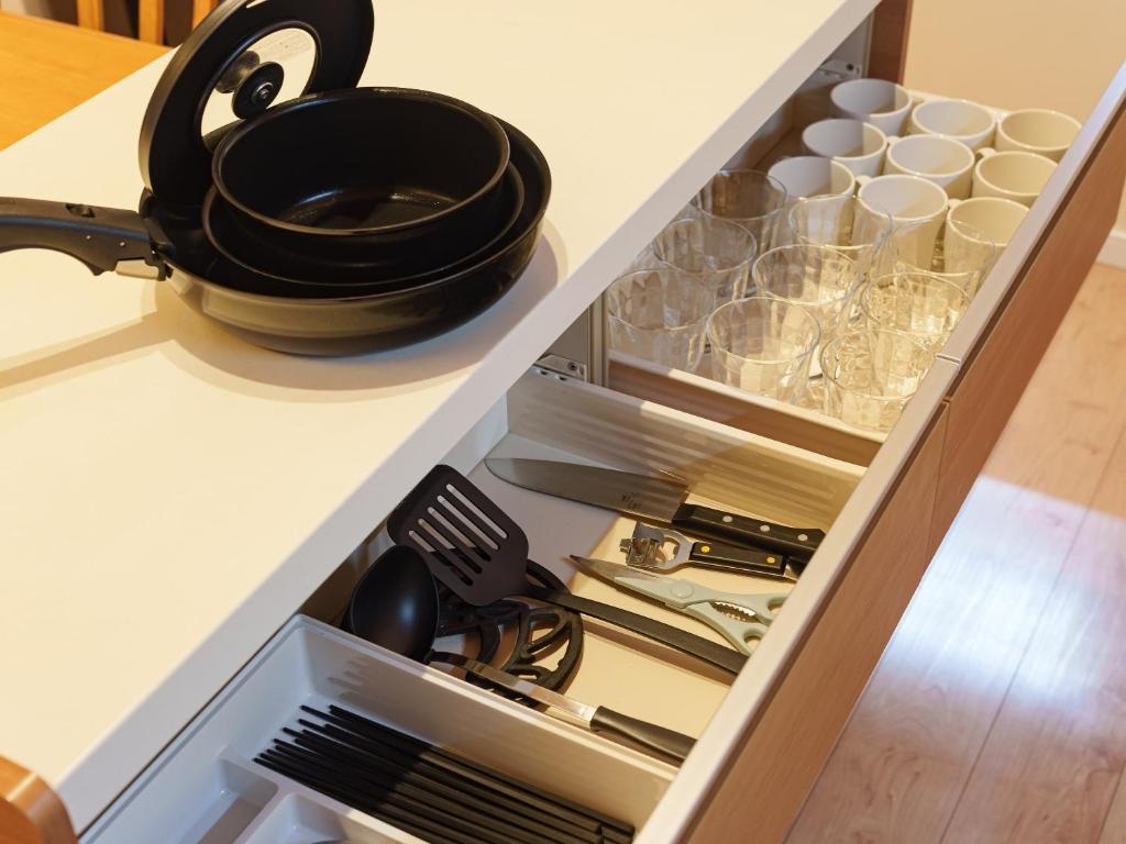 a kitchen drawer with a black pot on top at Aqua Palace Chatan by Coldio Premium in Chatan