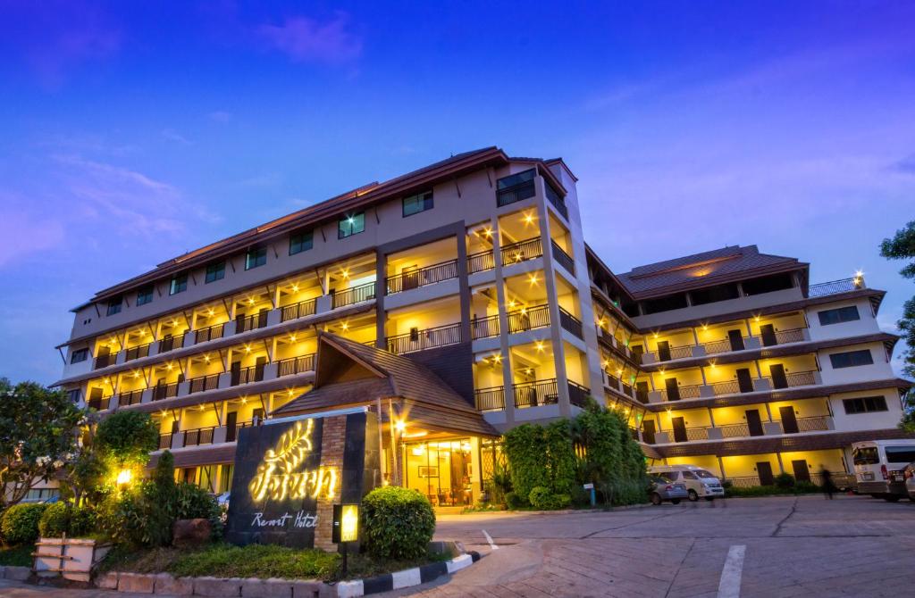 budynek z oświetlonym znakiem przed nim w obiekcie Panya Resort Hotel w mieście Udon Thani