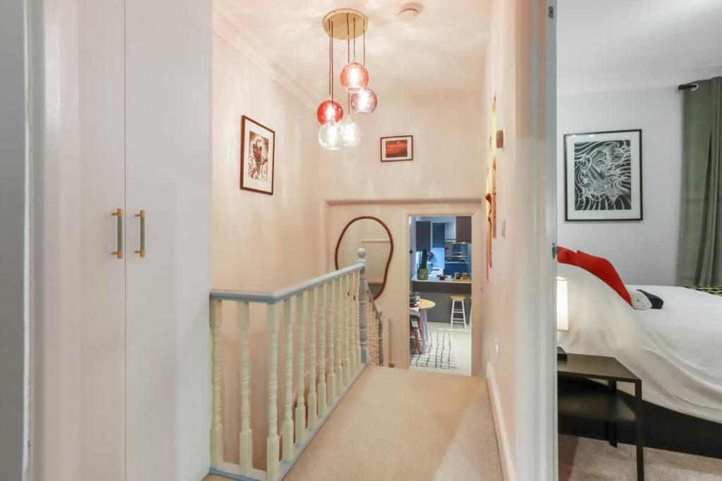 a hallway leading to a bedroom with a bed at Modern Double bedroom in city apartment room 2 in London