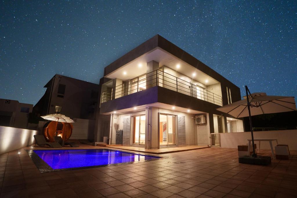 a house with a swimming pool at night at Villa Sirene Ishigaki in Ishigaki Island