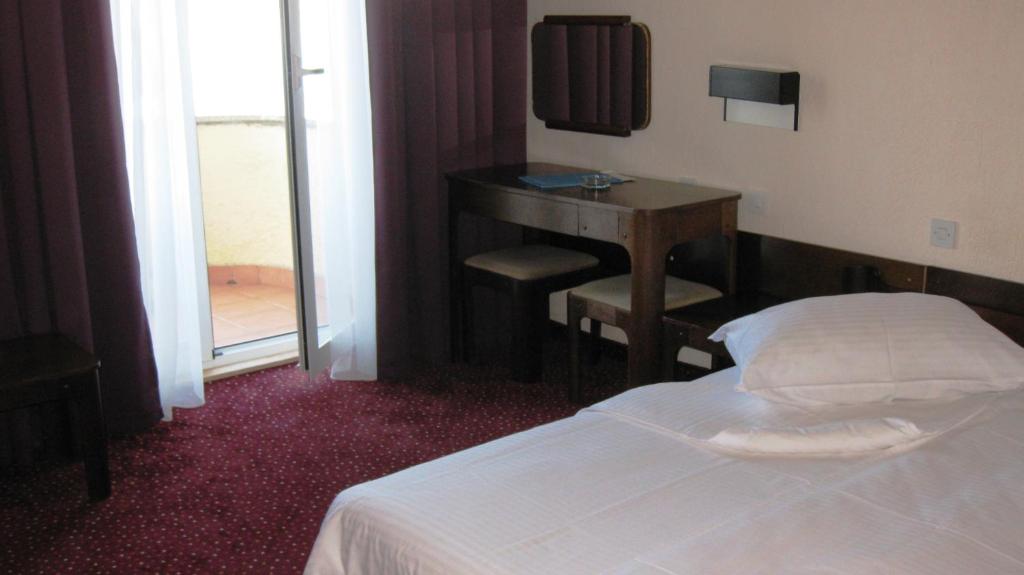 Postel nebo postele na pokoji v ubytování Hotel Kimen