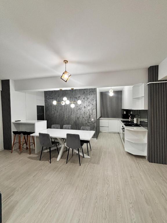 a kitchen and dining room with a table and chairs at Cozy Unique Penthouses with Terrace and Suceava Magic View in Suceava
