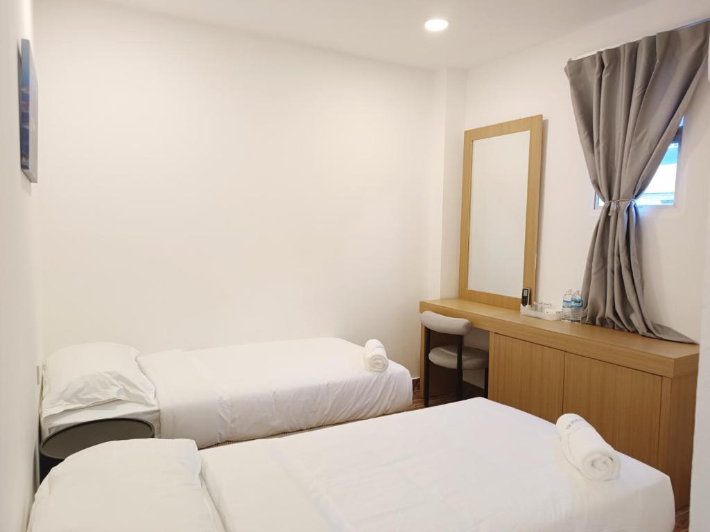 Postel nebo postele na pokoji v ubytování Shoreline Guesthouse 海岸线客栈