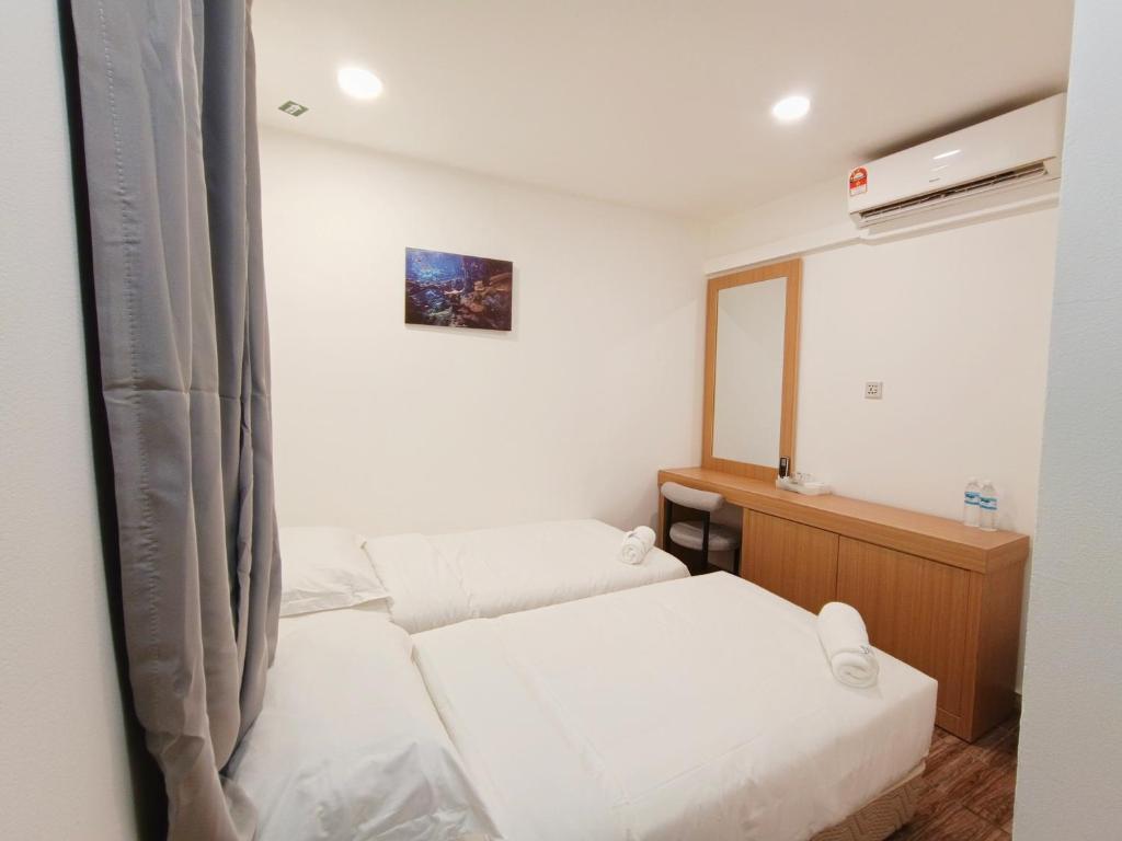 Postel nebo postele na pokoji v ubytování Shoreline Guesthouse 海岸线客栈
