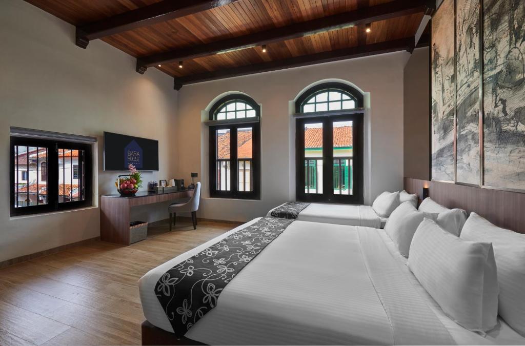 Postel nebo postele na pokoji v ubytování Baba House Melaka