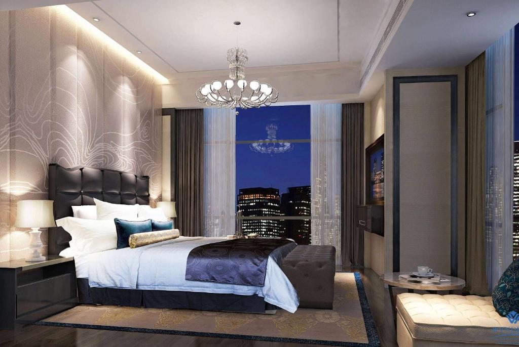 Postel nebo postele na pokoji v ubytování Wyndham Grand Foshan Gaoming