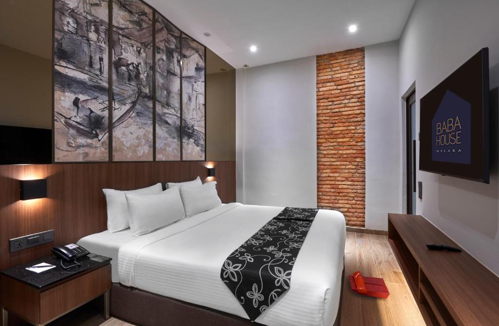 Postel nebo postele na pokoji v ubytování Baba House Melaka