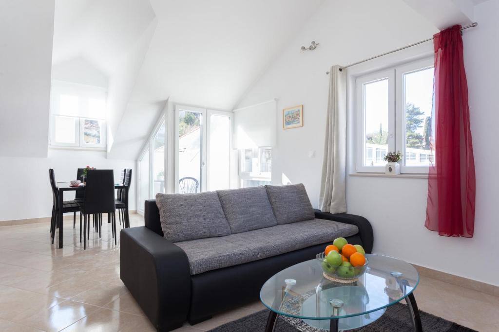 a living room with a couch and a glass table at Apartment Igneus A51 in Dubrovnik