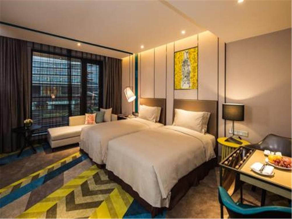 Postel nebo postele na pokoji v ubytování MiniMax Premier Hotel Shanghai Hongqiao