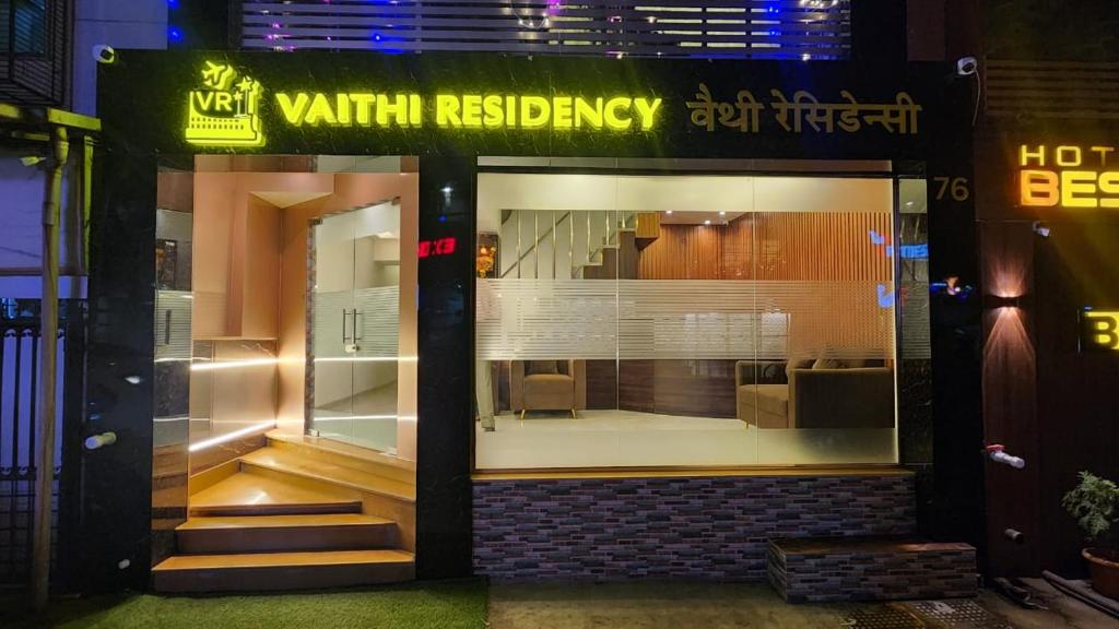 a store front with a large window with a chair in it at Hotel Vaithi Residency - Andheri West in Mumbai