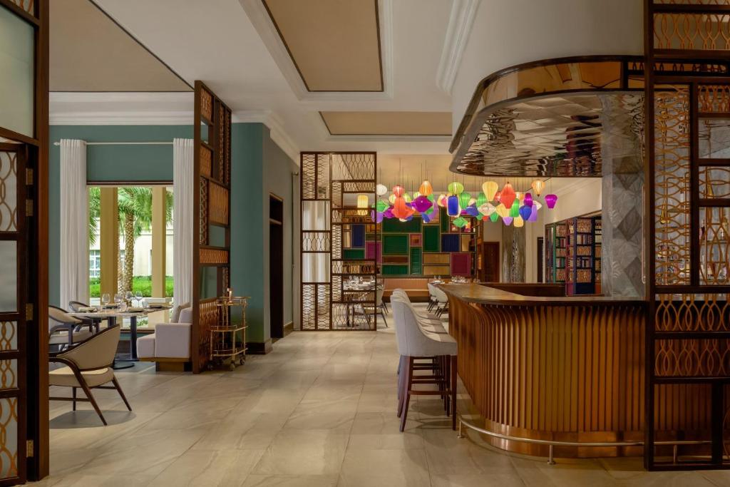 A richly decorated lobby lounge and bar with a library-style interior.