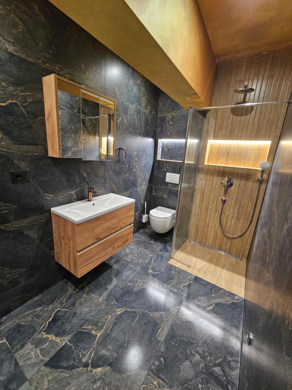 a bathroom with a sink and a toilet at Villa AS MOON with pool in Split