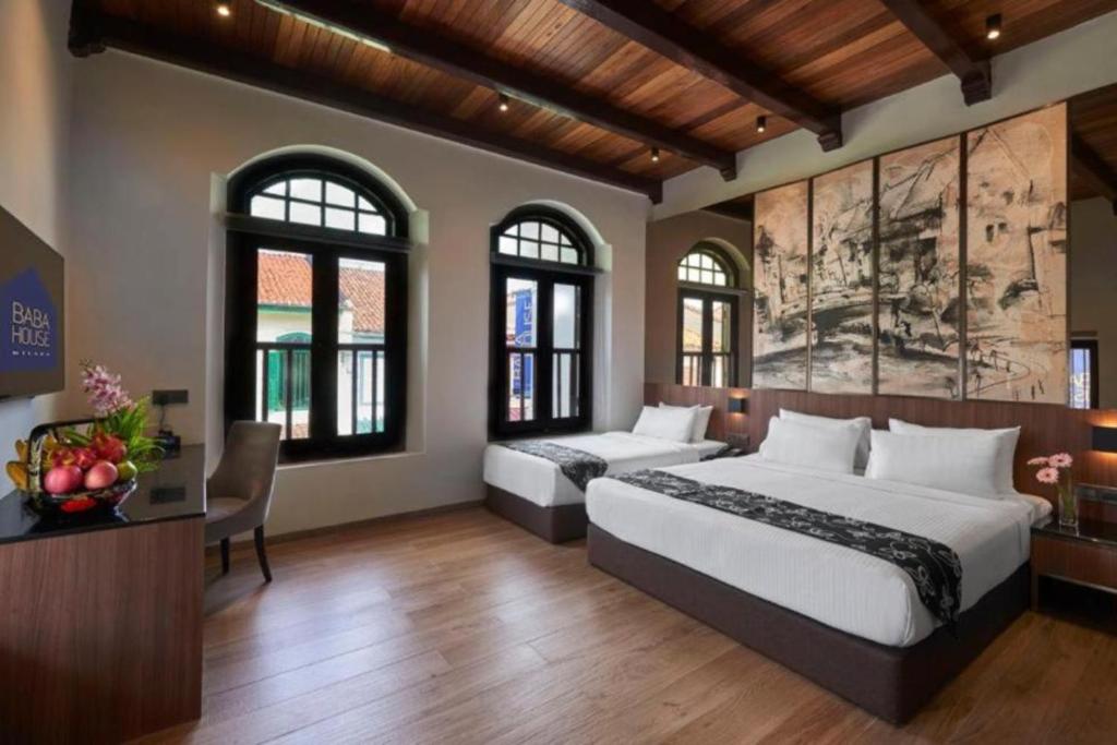 Postel nebo postele na pokoji v ubytování Baba House Melaka