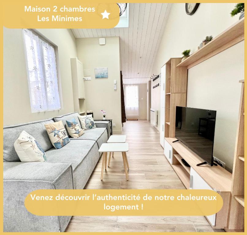a living room with a couch and a tv at Charmante Maison de Ville - Patio - Wifi - Parking gratuit in La Rochelle