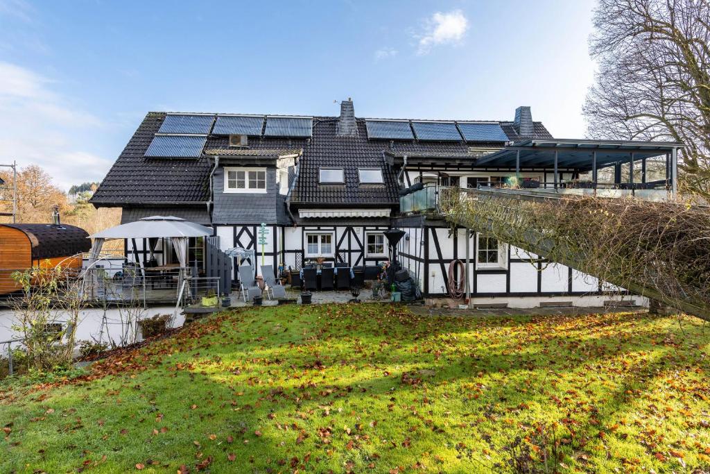a house with solar panels on top of it at Bergisch Resort Helle in Lindlar