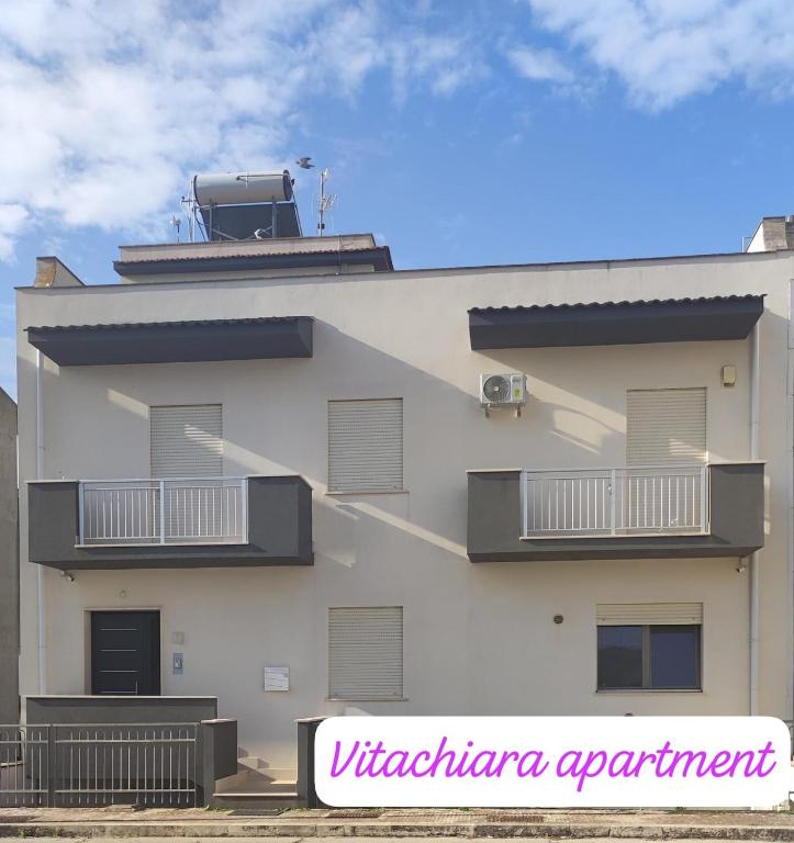 a white building with balconies on the side of it at Vitachiara Apartment - West Sicily Experience in Santa Ninfa
