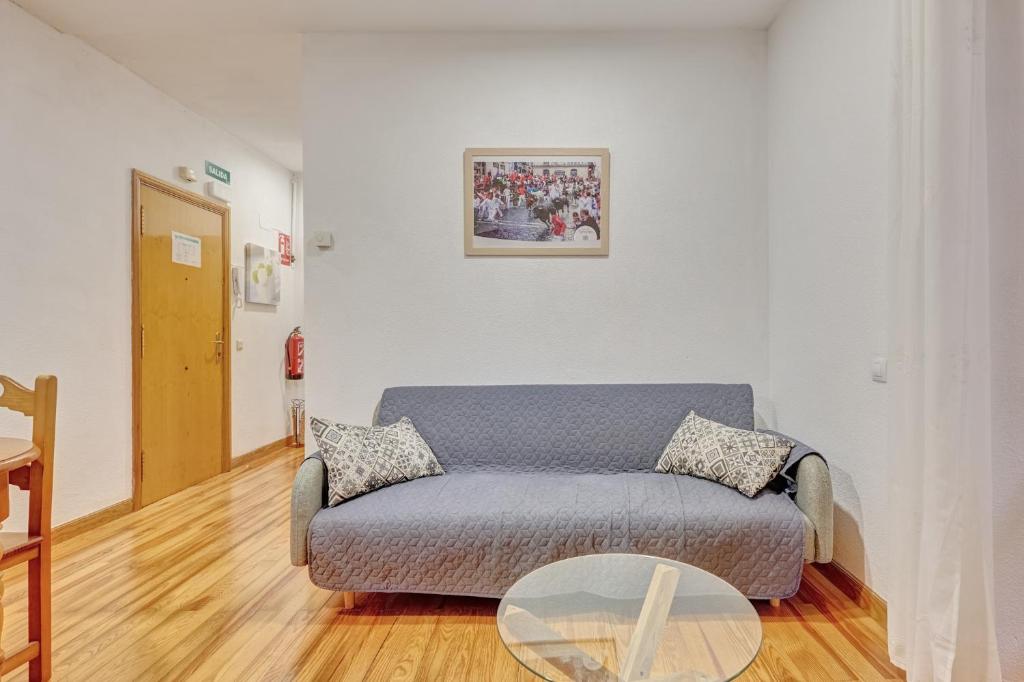 a living room with a couch and a glass table at Bajada de Javier by Clabao in Pamplona