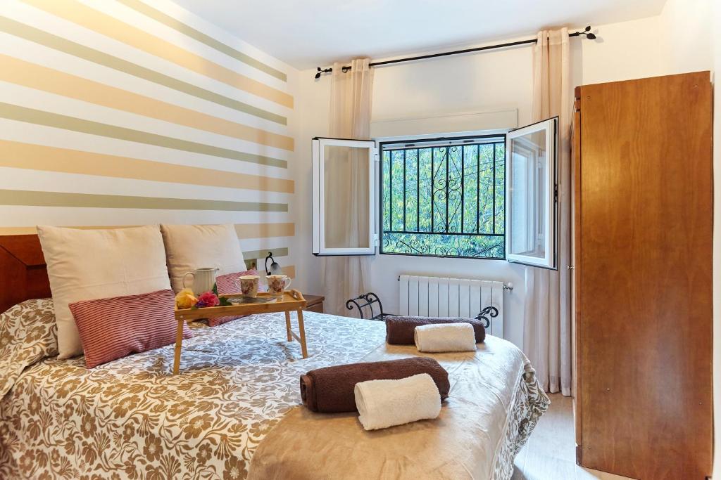 Postel nebo postele na pokoji v ubytování Casa Arroyo Colmenar