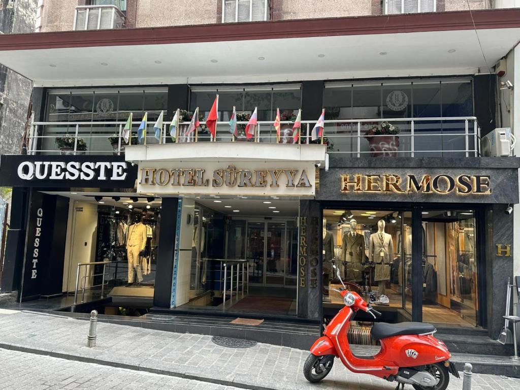 a red scooter parked in front of a store at Hotel Süreyya in Istanbul