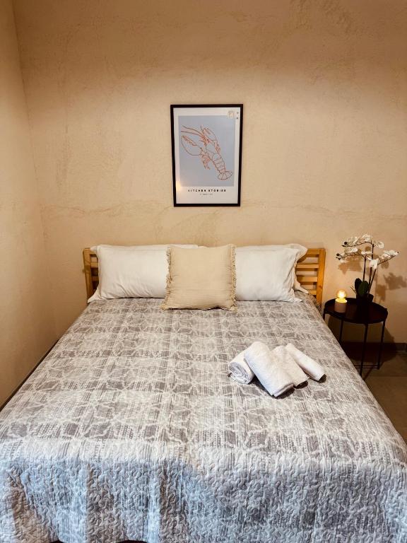 a bed with a blanket and two towels on it at Residence La Corte - Bilocale 4 in Novara