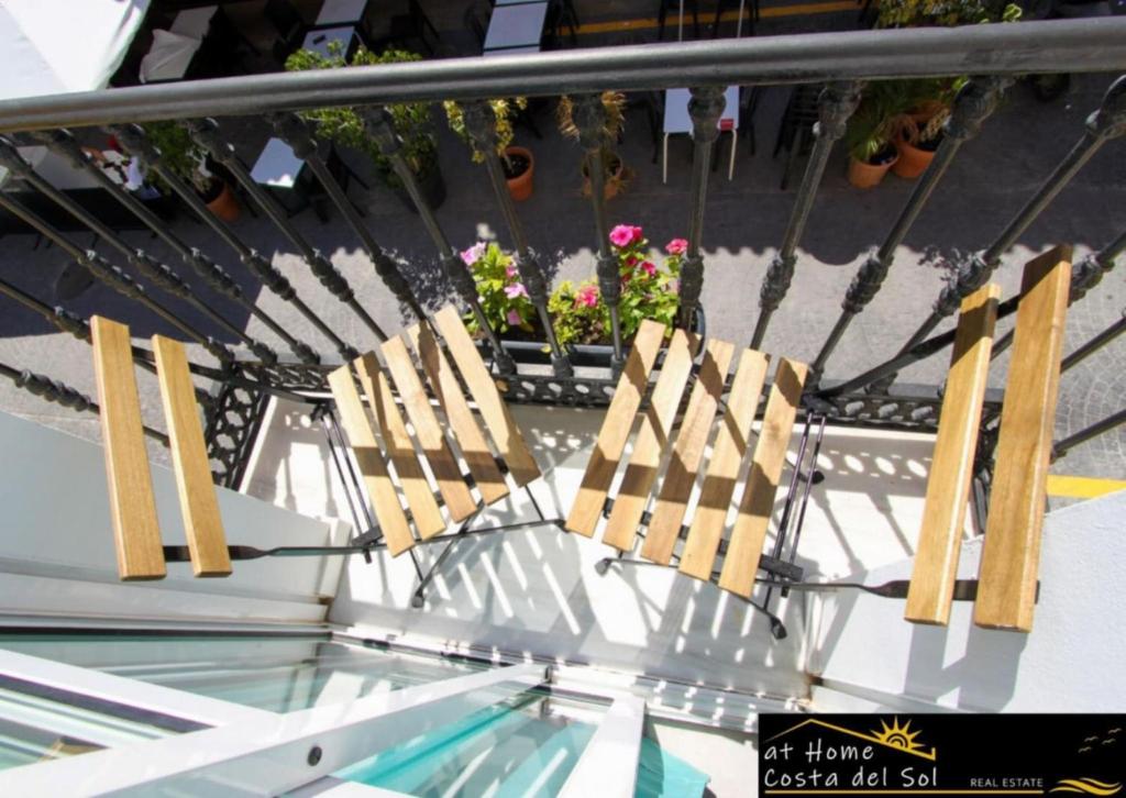 a pair of chairs sitting on top of a table at Apartamento en el centro de Nerja by At Home Costa del Sol in Nerja