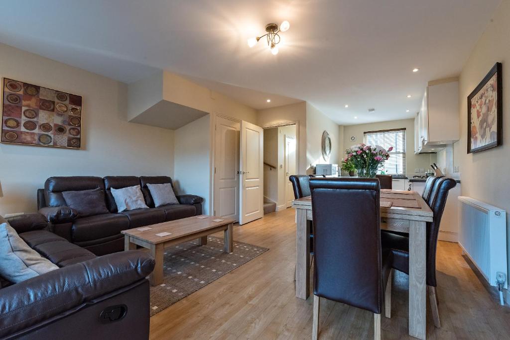 a living room with a couch and a table at Camstay New Street in Cambridge