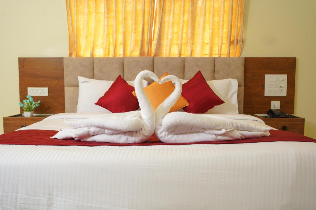 Postel nebo postele na pokoji v ubytování Hotel GSR Srinivasa Inn