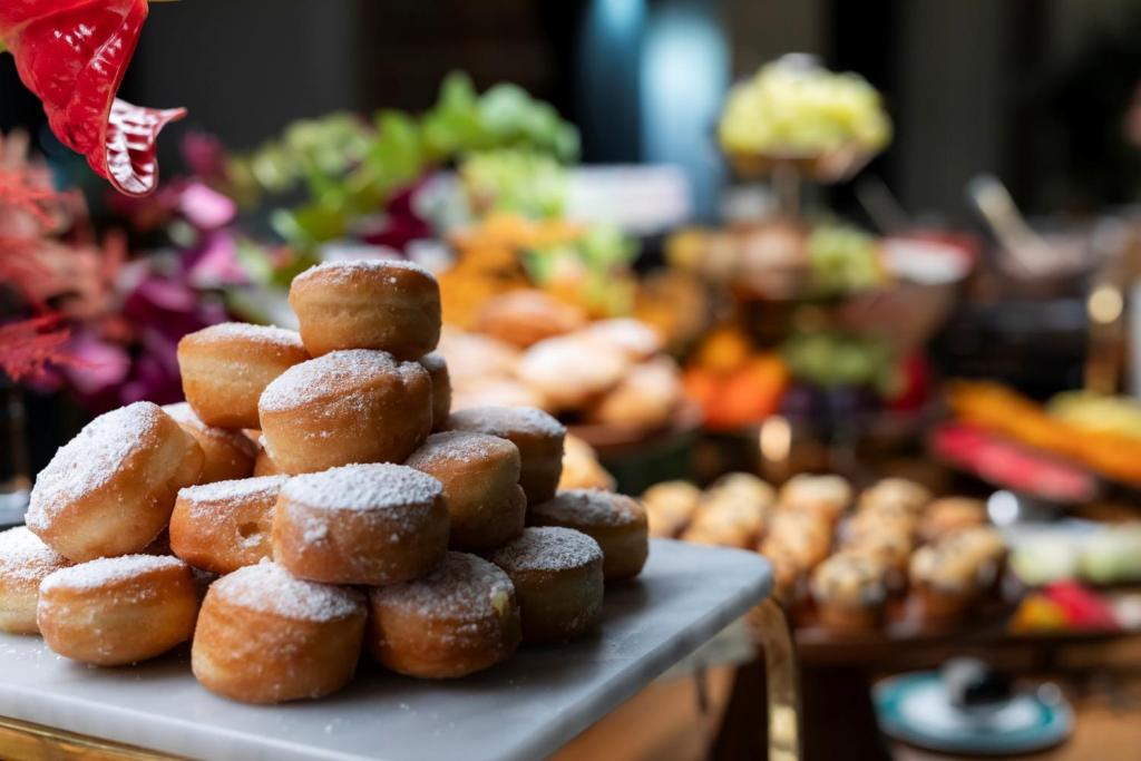 a pile of sugar covered donuts on a table at Ca' Bonfadini Historic Experience in Venice