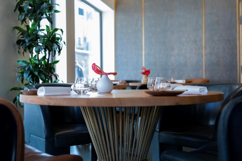 a wooden table in a restaurant with glasses on it at Ca' Bonfadini Historic Experience in Venice