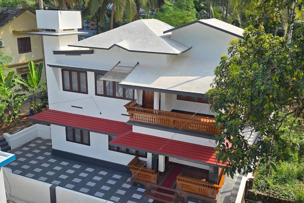 an overhead view of a white house with red balconies at Entire 4 Bedroom Villa in Kannur in Edakkād