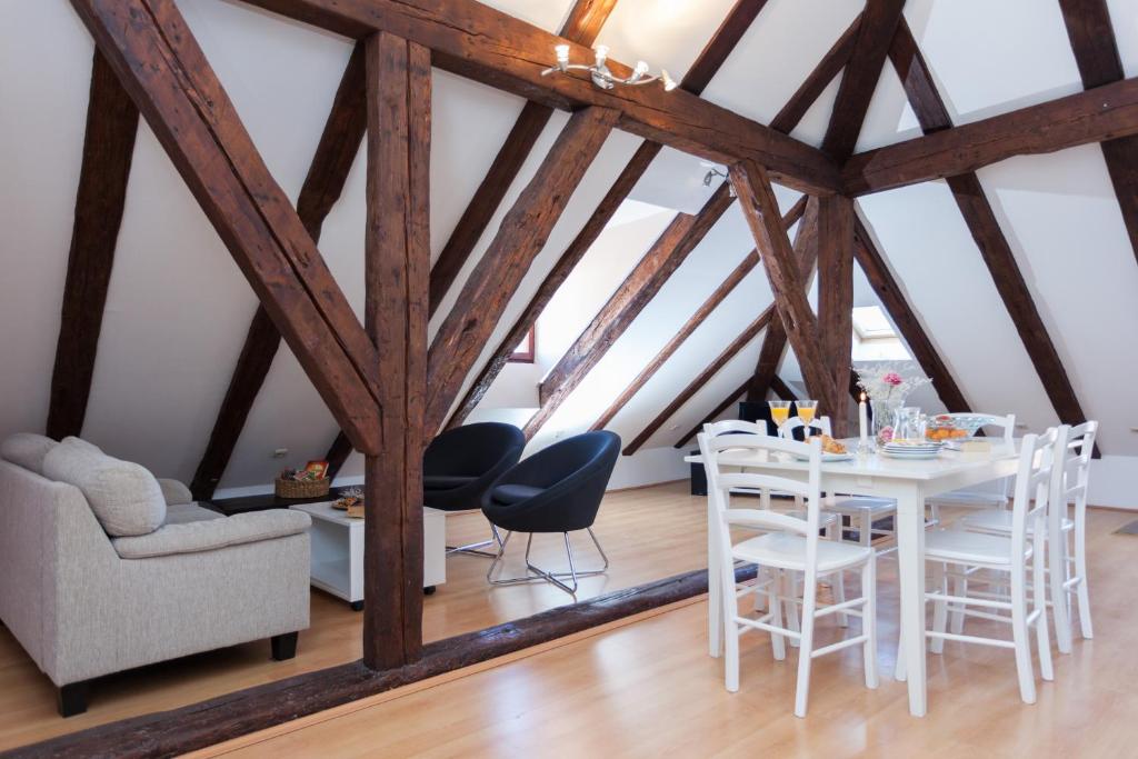 a dining room with a white table and chairs at Apartment Melano A5 in Dubrovnik