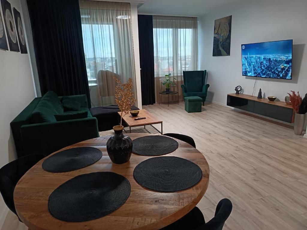a living room with a wooden table in a room at Downtown28 apartment in Poprad
