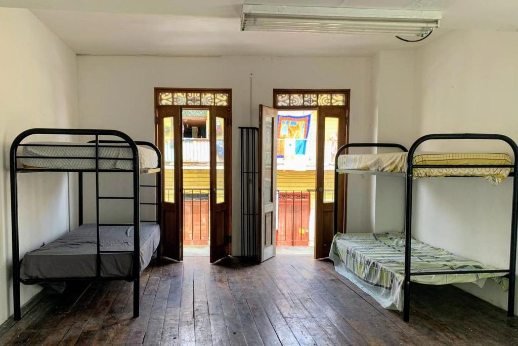 a room with three bunk beds in a room at Casa Vintage in Panama City