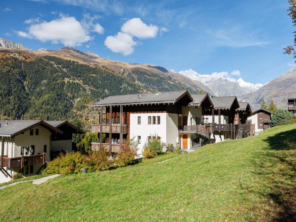 a resort on a hill with mountains in the background at Apartment Aragon T100 by Interhome in Fiesch