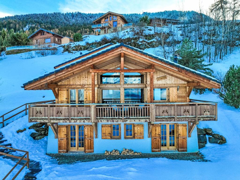 a log home in the winter with snow at Chalet Gingembre 12 by Interhome in Nendaz