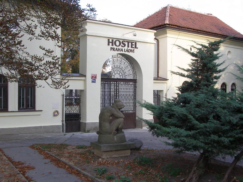 a statue in front of a building at Hostel Praha Ládví in Prague