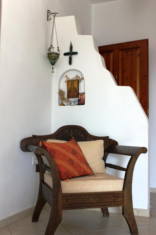a bench with pillows on it in a room at Galini in Agia Irini Milos