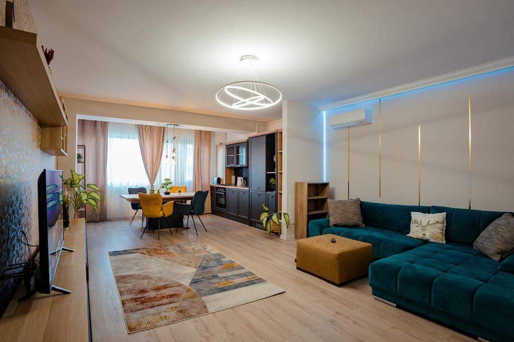 a living room with a blue couch and a table at Blvd Ivory Pipera ap 60A in Voluntari