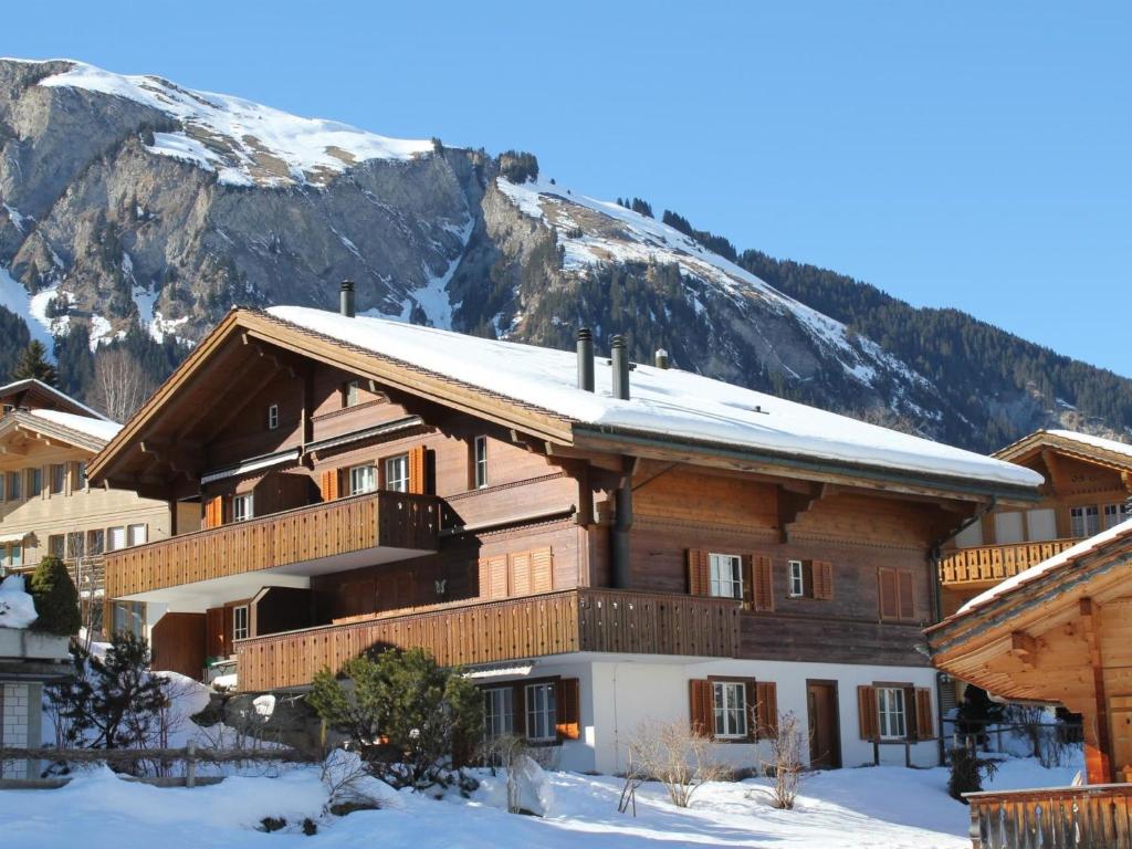 a ski lodge with a mountain in the background at Apartment Rottäli OG by Interhome in Lenk