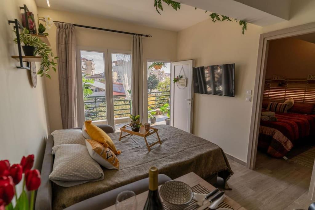a living room with a bed and a balcony at Luxury rooftop in Larisa