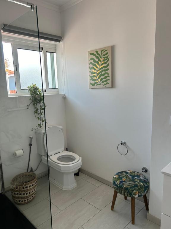 a white bathroom with a toilet and a window at MAR VERDE - Parede-Cascais in Parede