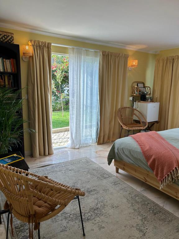 a bedroom with a bed and a large window at MAR VERDE - Parede-Cascais in Parede
