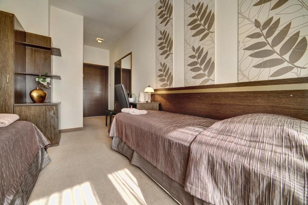 Posteľ alebo postele v izbe v ubytovaní Hotel Orlik