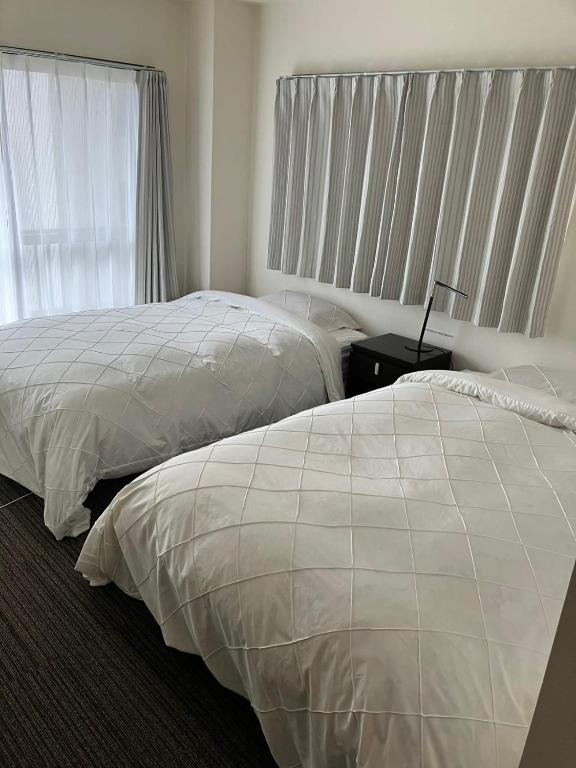 Postel nebo postele na pokoji v ubytování 山中ビル3Fーワンフロア貸切48平方メートルone floor private room